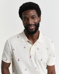 MODEL WEARING EMBROIDERED GRAPHIC POLO