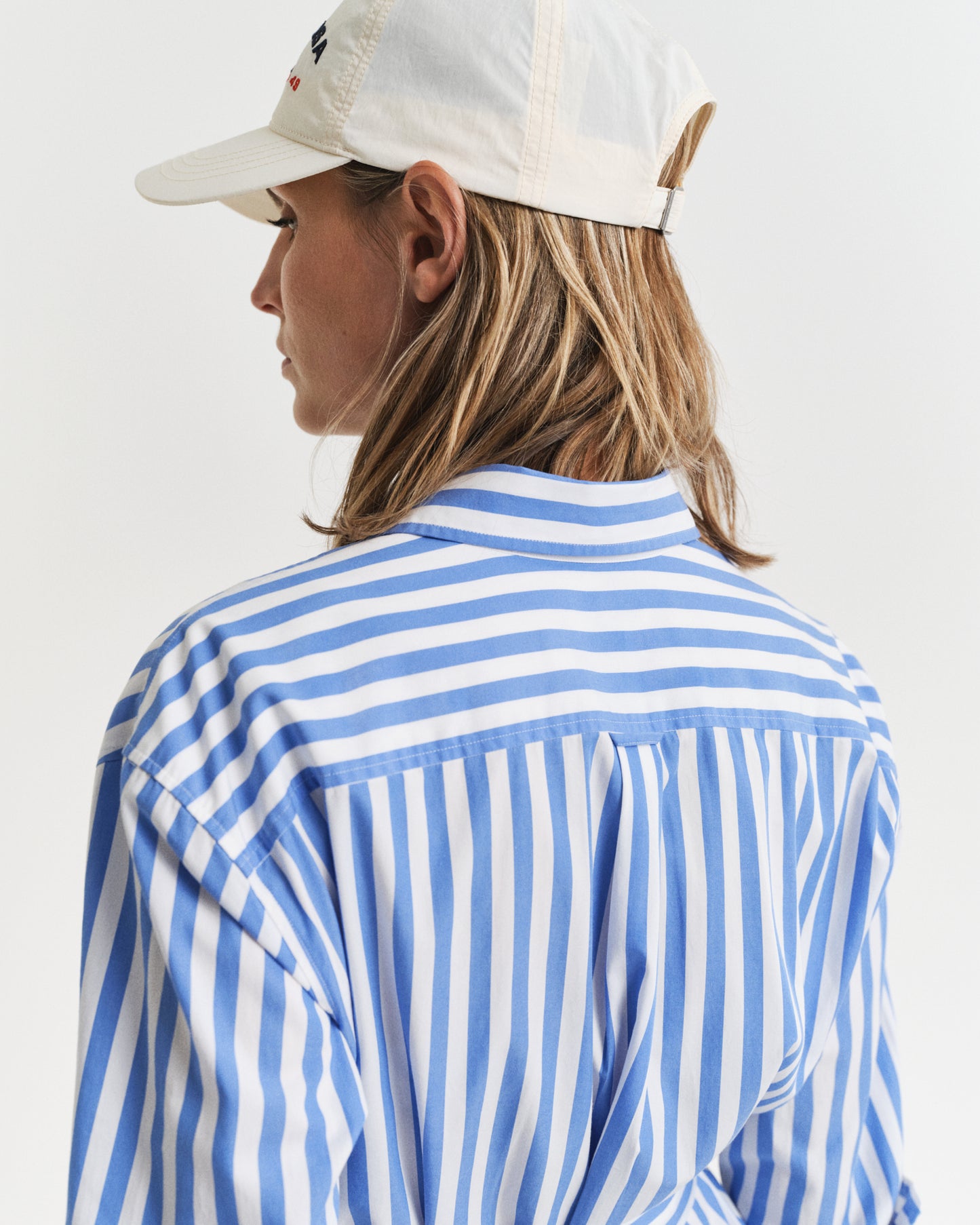 MODEL WEARING REL STRIPED POPLIN SHIRT DRESS