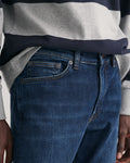 MODEL WEARING SLIM GANT JEANS