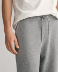 MODEL WEARING REG SHIELD SWEATPANTS