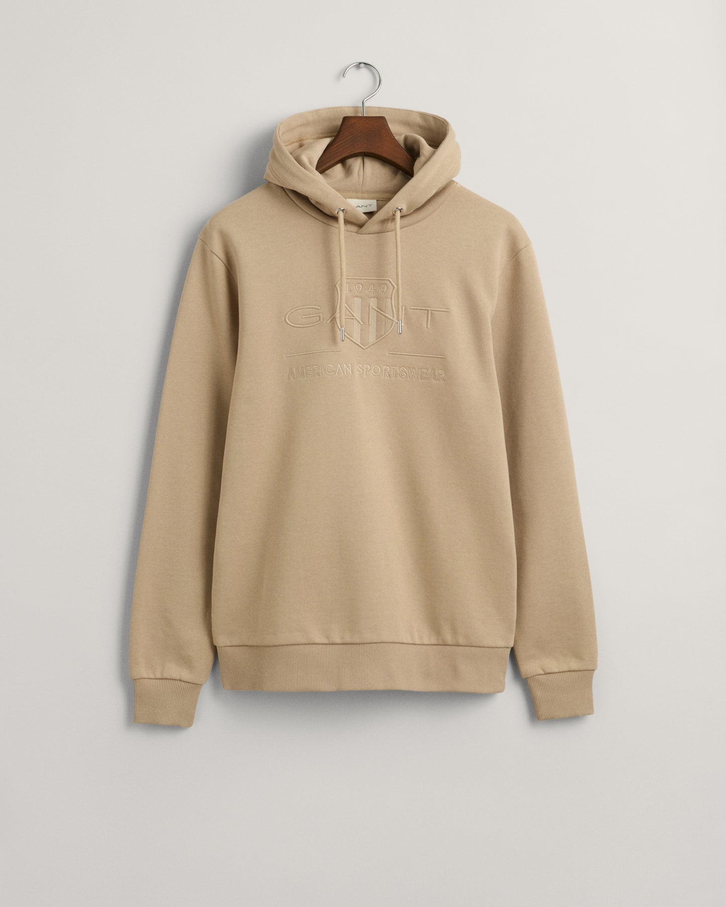 CONCRETE BEIGE, REG TONAL SHIELD HOODIE, FLAT-LAY BY GANT AU.