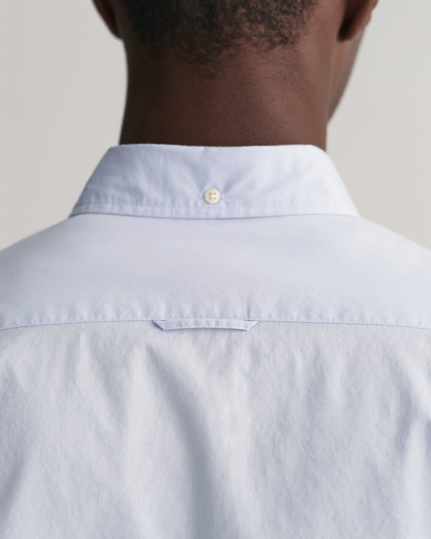 MODEL WEARING SLIM POPLIN SHIRT