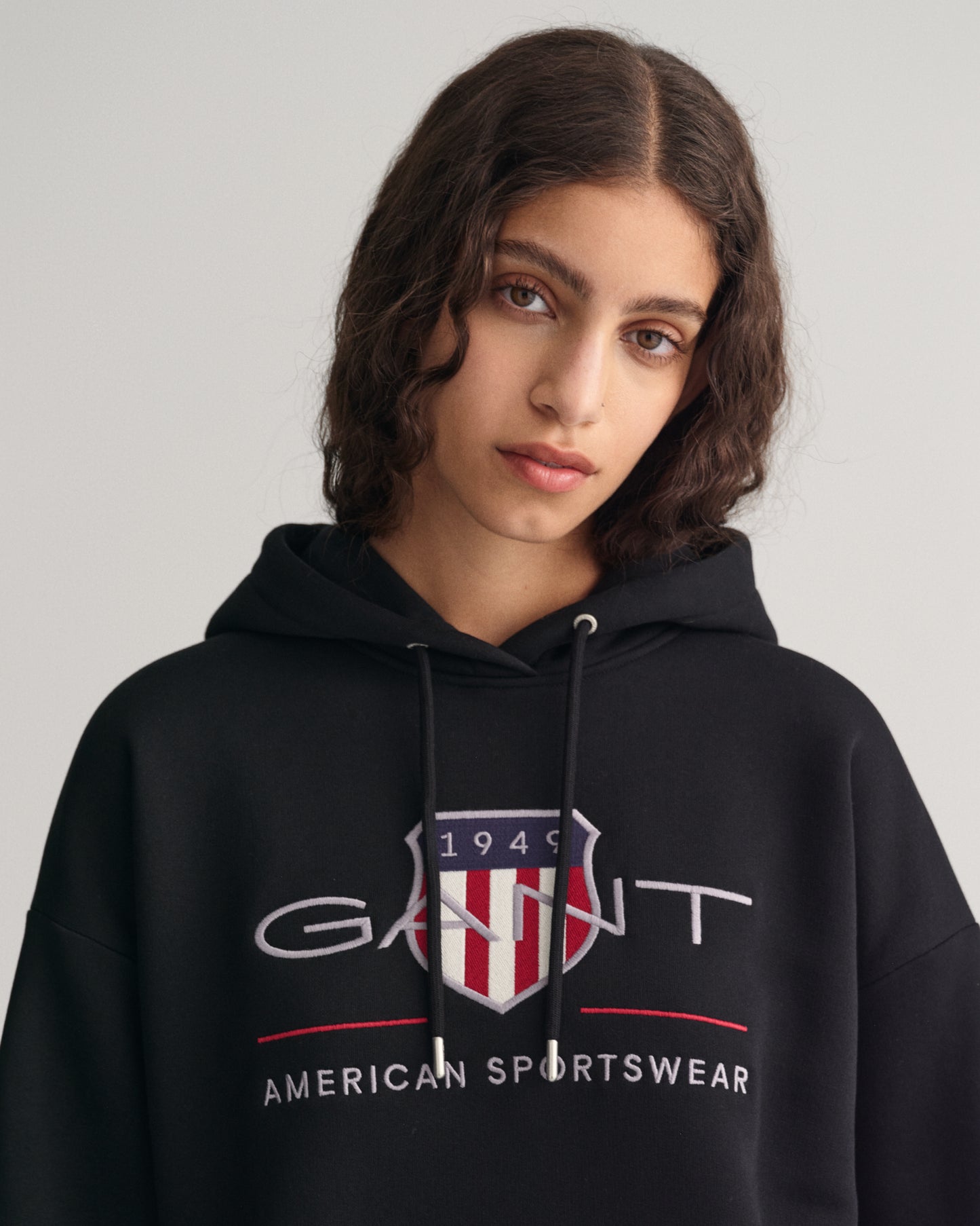 MODEL WEARING REL ARCHIVE SHIELD HOODIE