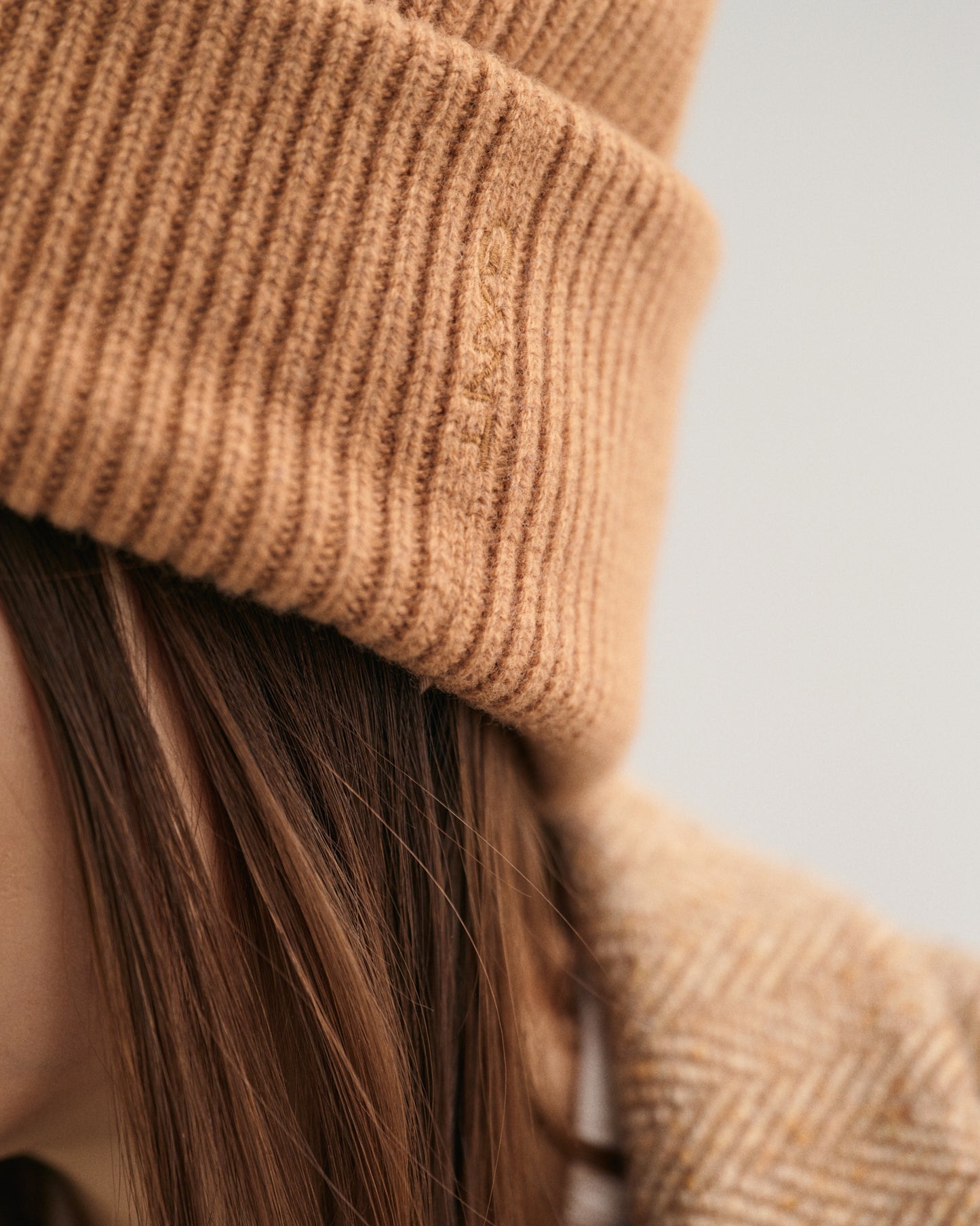 MODEL WEARING WOOL RIBBED BEANIE