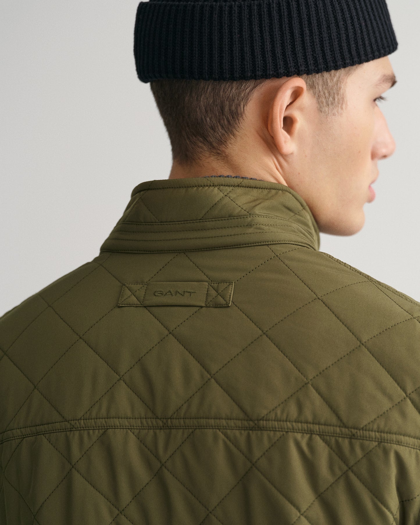 MODEL WEARING QUILTED WINDCHEATER VEST