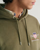 MODEL WEARING REG MEDIUM ARCHIVE SHIELD HOODIE