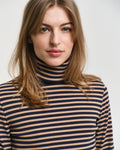 MODEL WEARING SLIM STRIPED RIBBED TURTLENECK