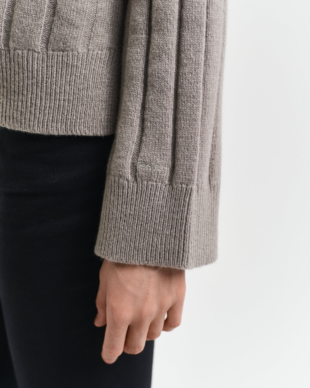 MODEL WEARING WIDE RIBBED WOOL STAND COLLAR