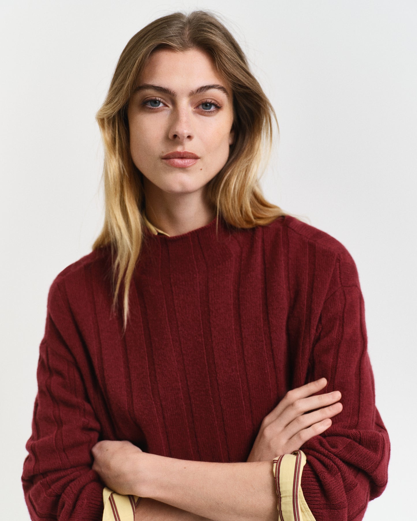 MODEL WEARING WIDE RIBBED WOOL STAND COLLAR