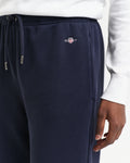MODEL WEARING REG SHIELD SWEATPANTS
