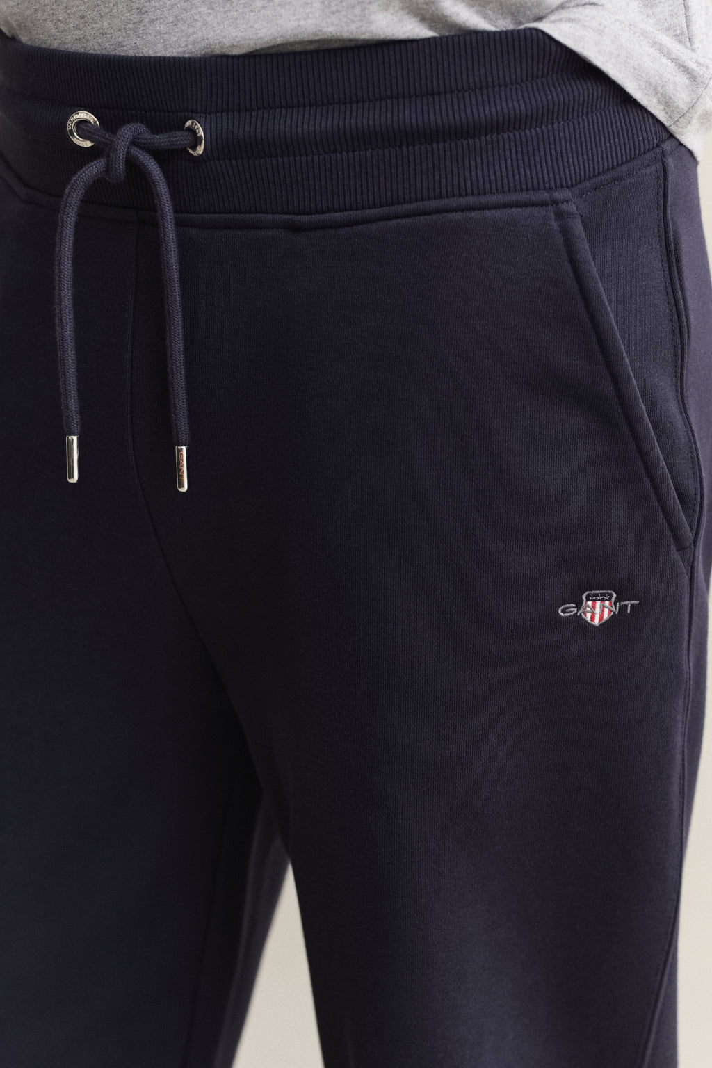 MODEL WEARING REG SHIELD SWEATPANTS