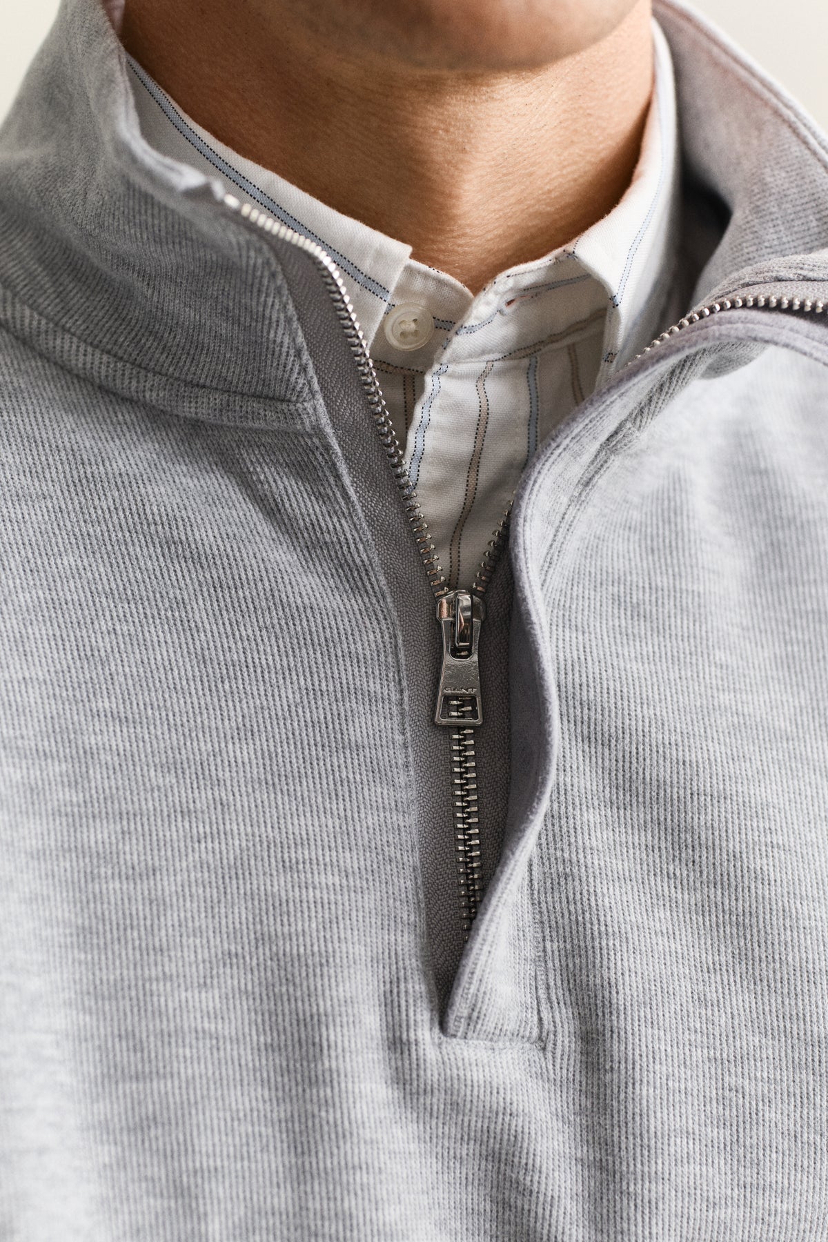 MODEL WEARING LIGHT SACKER HALF ZIP
