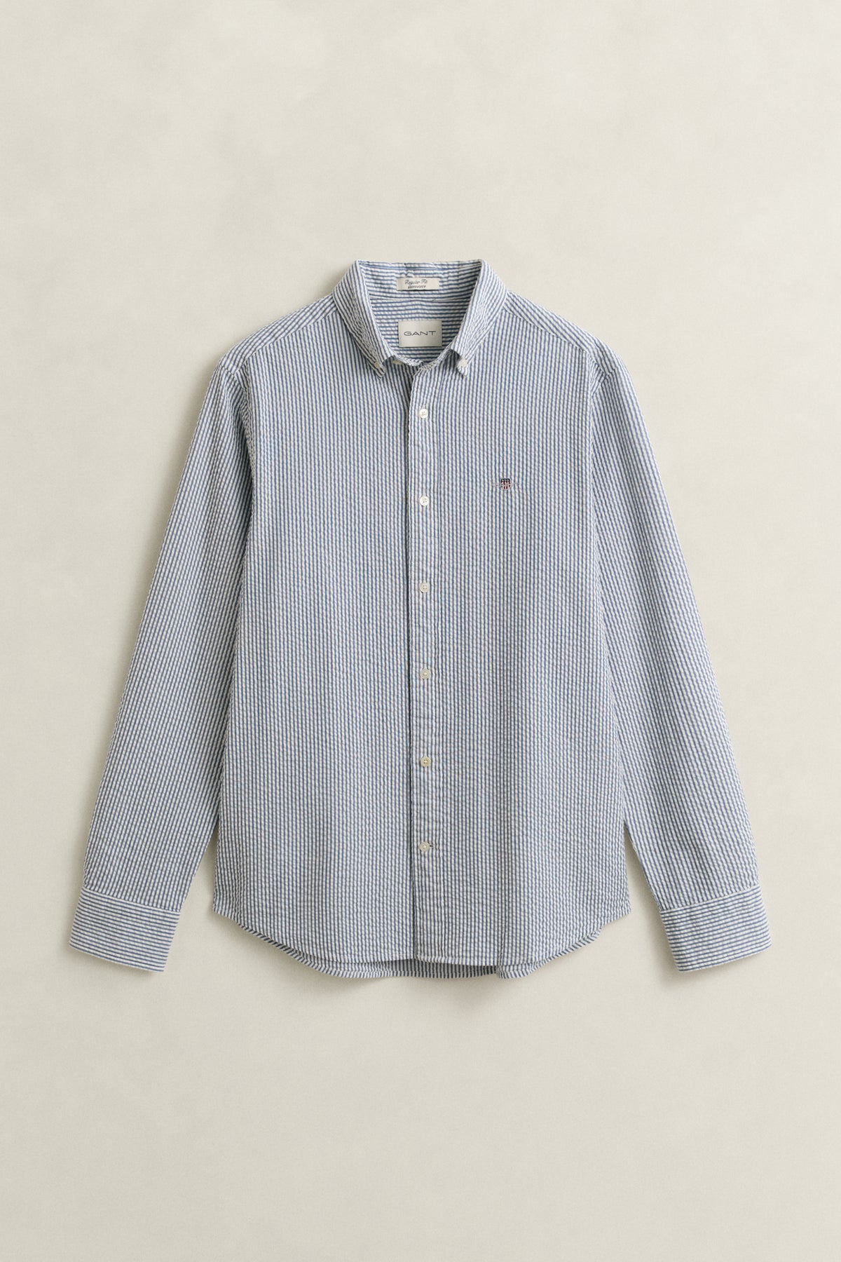 VINTAGE BLUE, REG SEERSUCKER STRIPE SHIRT, FLAT-LAY BY GANT AU.