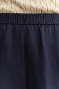 MODEL WEARING LINEN BLEND PULL ON SHORTS