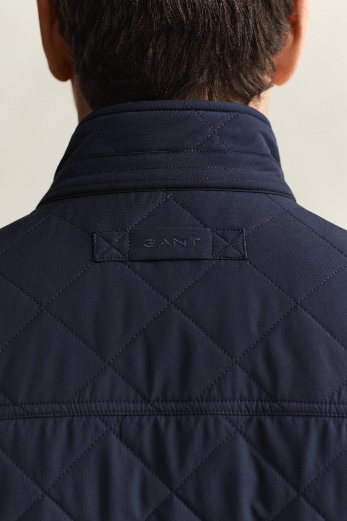 MODEL WEARING QUILTED WINDCHEATER VEST