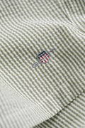 DRY HERB GREEN, STRIPED SEERSUCKER SWIM SHORTS, FLAT-LAY BY GANT AU.